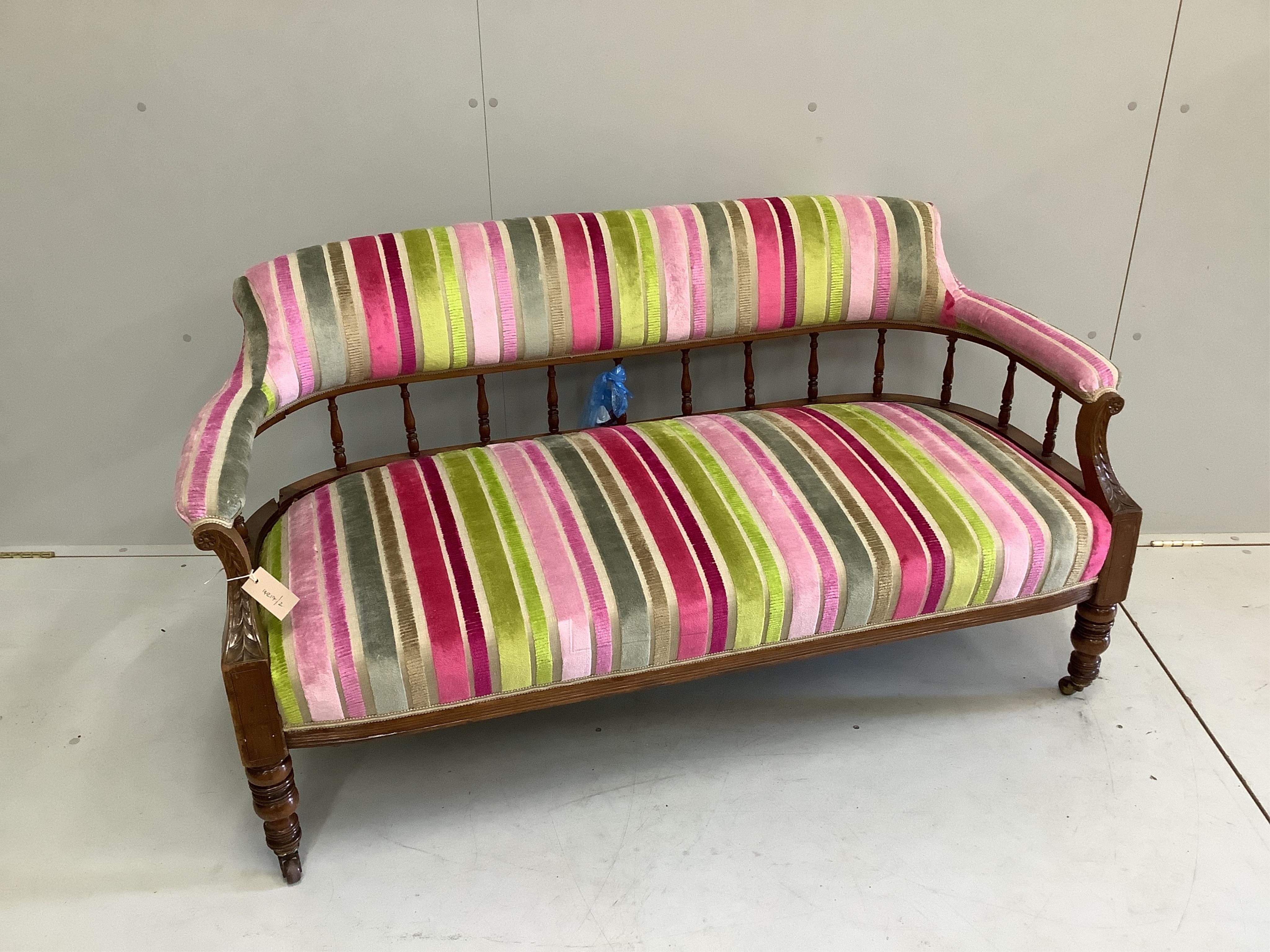 A Victorian mahogany settee re-upholstered in contemporary striped fabric, width 140cm, depth 60cm, height 74cm